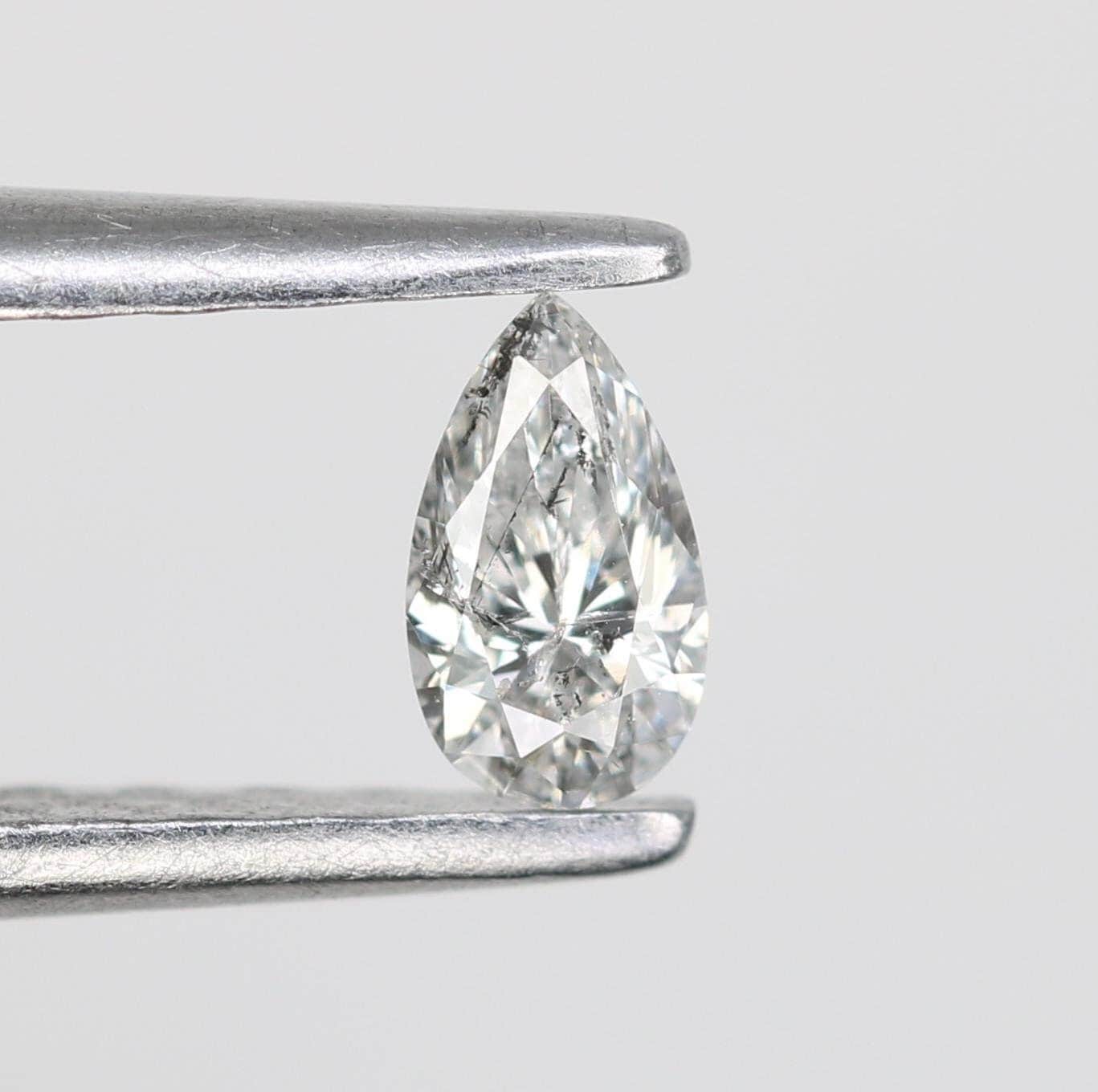 0.16 CT Elegant Natural White Salt and Pepper Pear Shape Diamond - Unique Loose Gemstone for Engagement Rings and Custom Jewelry Designs.