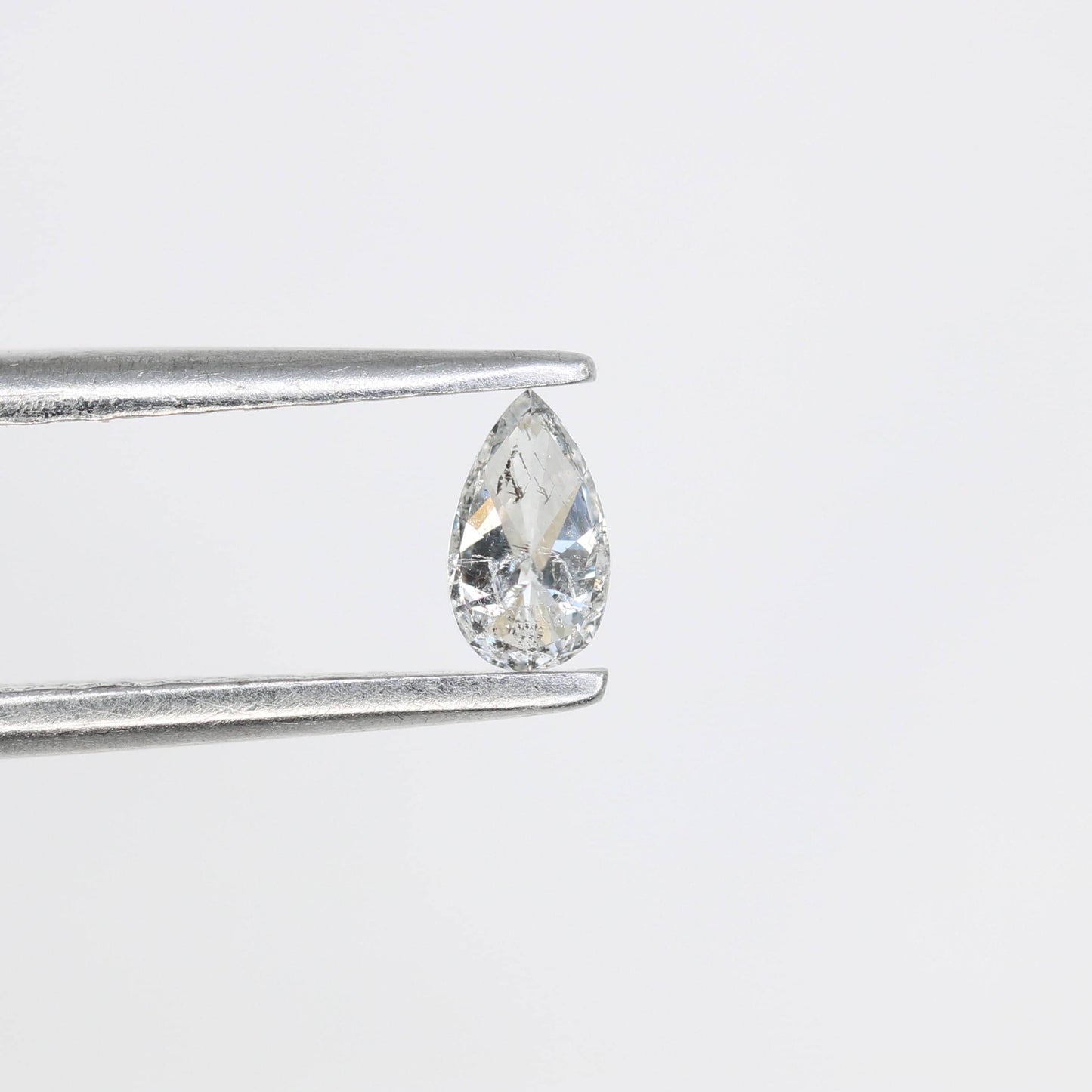 0.16 CT Elegant Natural White Salt and Pepper Pear Shape Diamond - Unique Loose Gemstone for Engagement Rings and Custom Jewelry Designs.