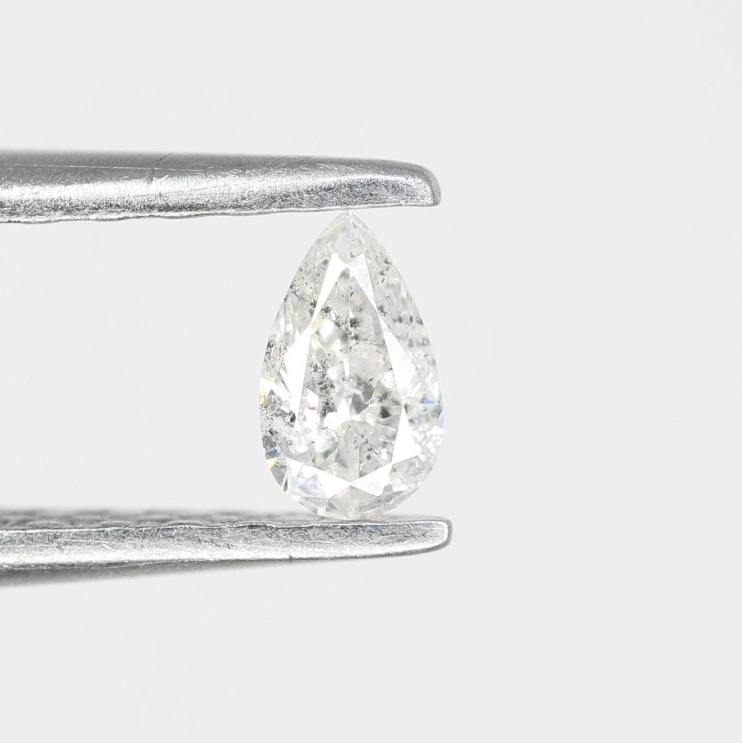 0.13 CT Natural White Salt and Pepper Pear Shape Diamond - Stunning Loose Gemstone Perfect for Custom Rings and Unique Jewelry Designs.