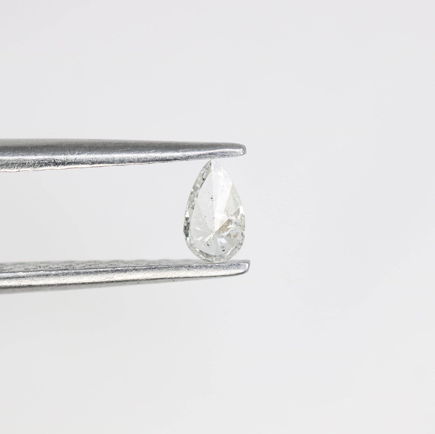 0.13 CT Natural White Salt and Pepper Pear Shape Diamond - Stunning Loose Gemstone Perfect for Custom Rings and Unique Jewelry Designs.